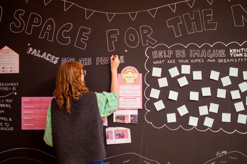 Person drawing on wall inside Civic Action Lab