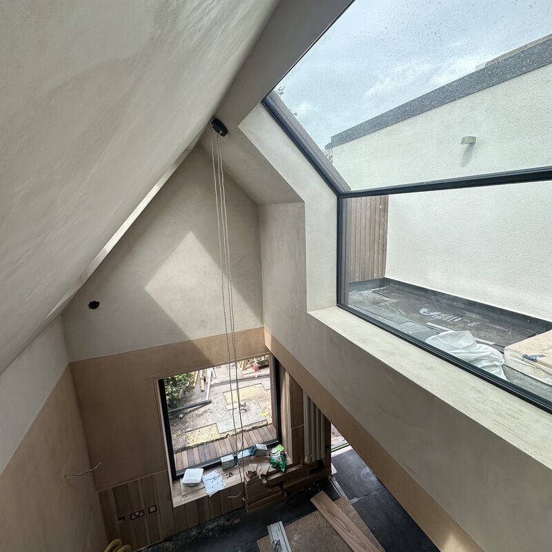 View from mezzanine. Formed in hemp block, flexible hemp & solid woodfibre, clay plaster finish.