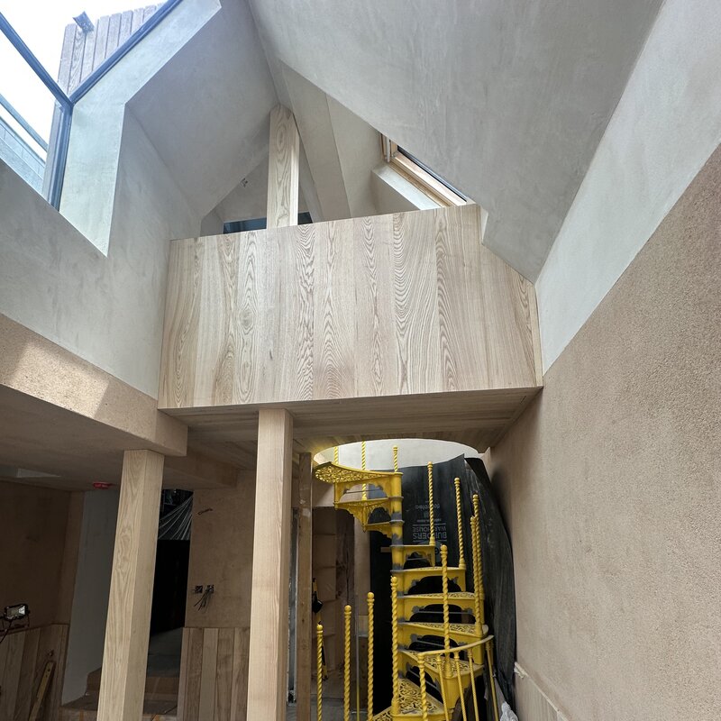 View of UK grown ash mezzanine and salvaged spiral stair.