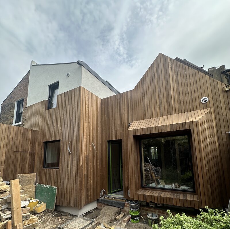 View of retrofit & extension: lime plaster & UK Brimstone Ash finish over woodfibre/hemp insulations